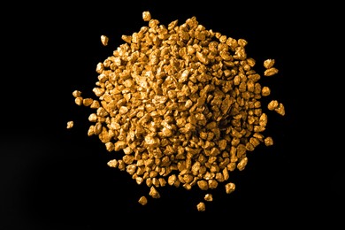 Photo of Pile of gold nuggets on black background, flat lay