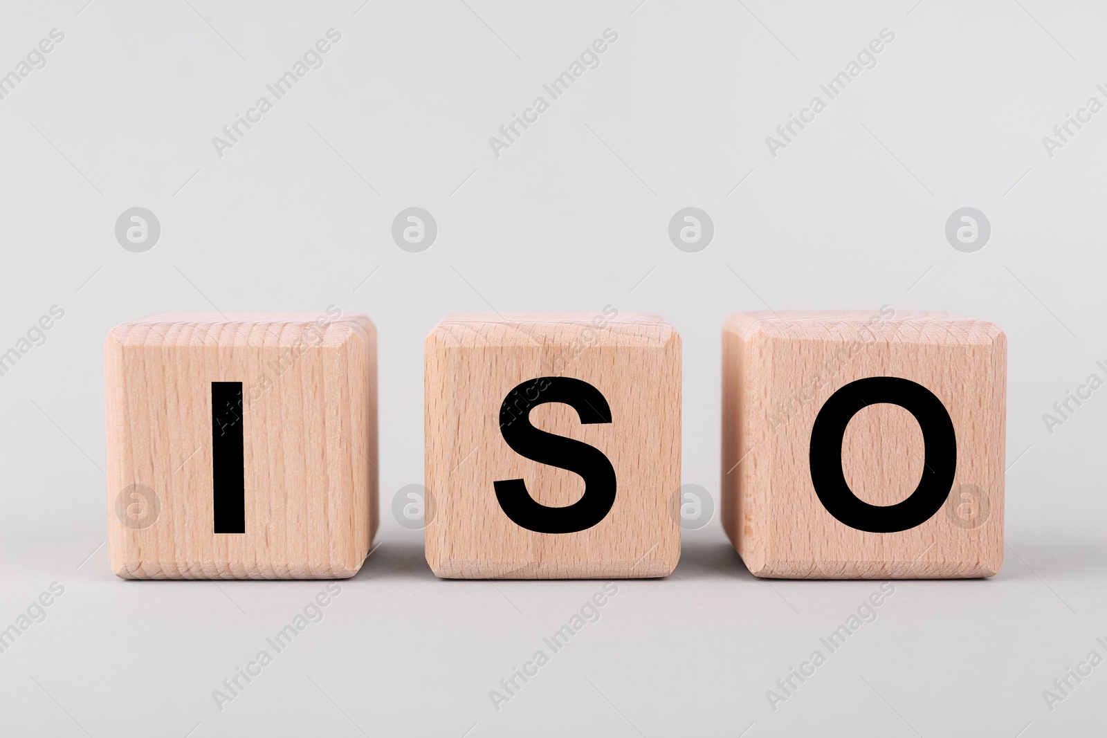 Photo of International Organization for Standardization. Cubes with abbreviation ISO on light grey background, closeup