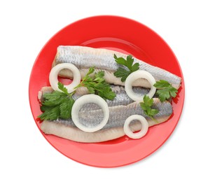 Photo of Red plate with delicious salted herring fillets, onion rings and parsley isolated on white, top view