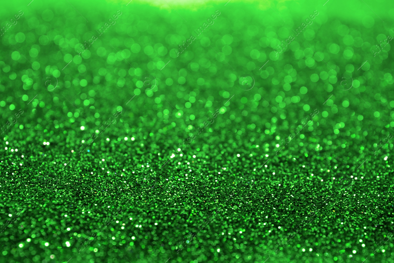 Image of St. Patrick day. Shiny green glitter, closeup. Bokeh effect