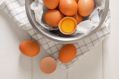 Fresh raw chicken eggs on white wooden table, flat lay