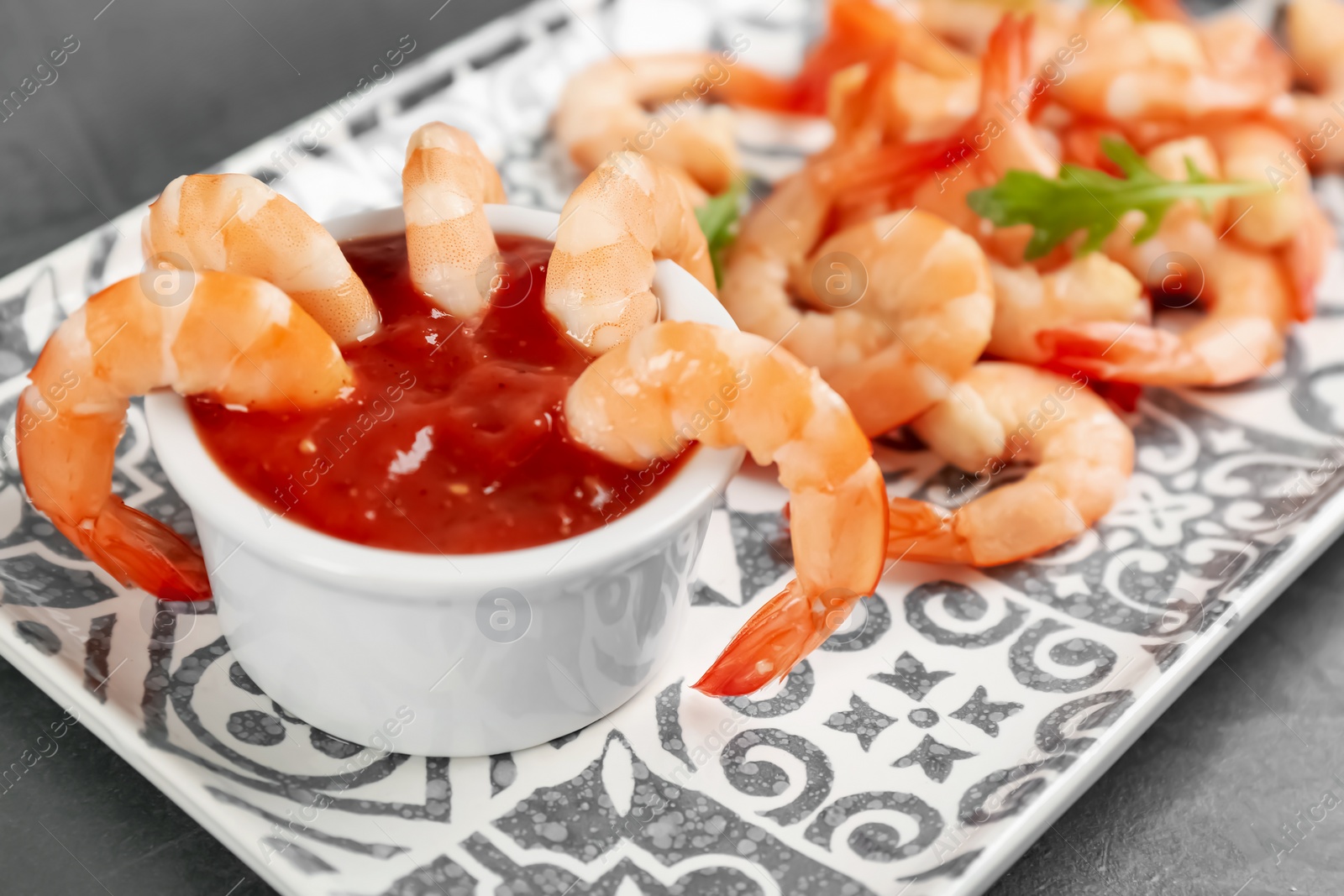 Photo of Delicious shrimp cocktail with tomato sauce, closeup