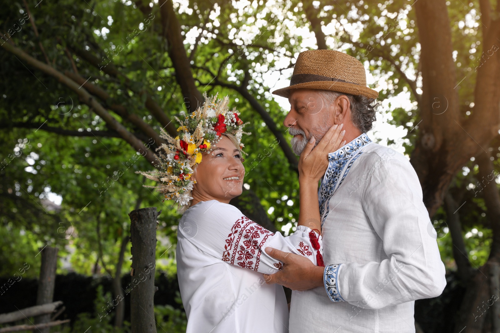 Photo of Happy mature couple in Ukrainian national clothes outdoors