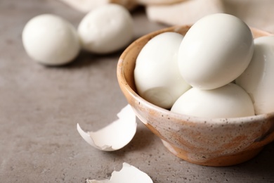 Photo of Bowl with boiled eggs on table. Space for text