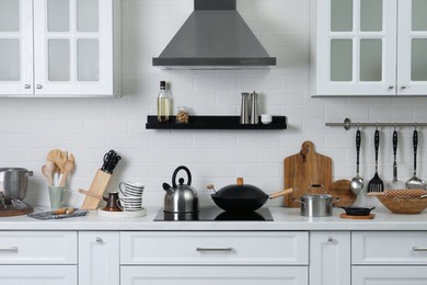 Countertop with different cooking utensils in kitchen