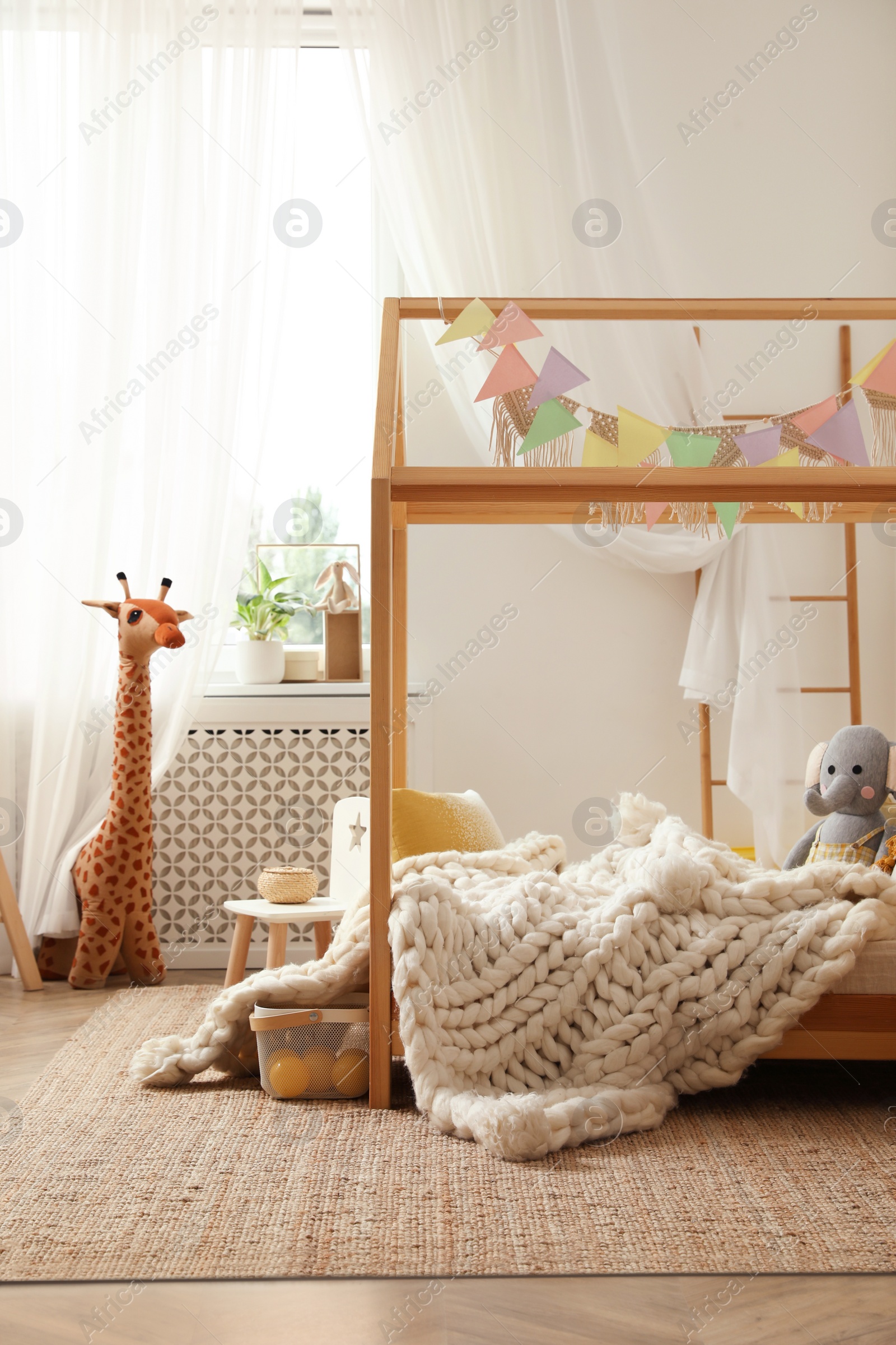 Photo of Stylish child room interior with house bed