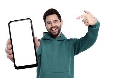 Happy man holding smartphone with empty screen on white background