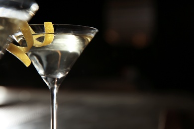 Photo of Glass of lemon drop martini cocktail in bar, closeup. Space for text