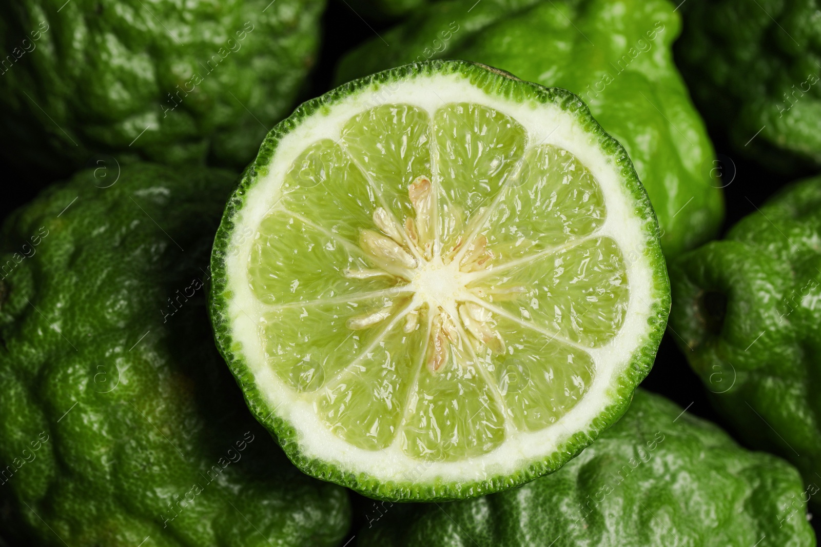 Photo of Whole and cut ripe bergamot fruits as background, top view