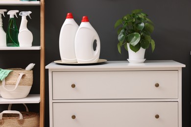 Laundry room interior with wooden chest of drawers and rack