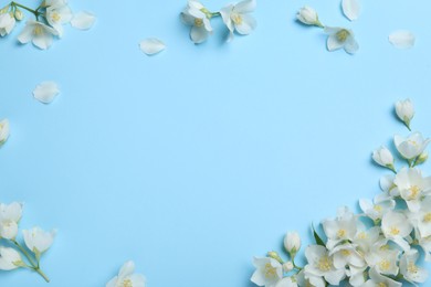 Beautiful jasmine flowers on turquoise background, flat lay. Space for text