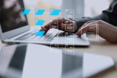 Electronic document management. Woman working on laptop at table, closeup