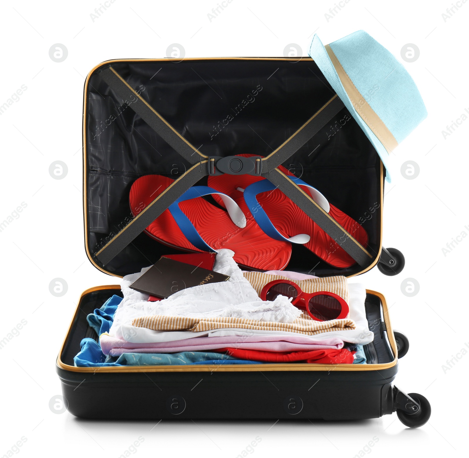 Photo of Packed suitcase with clothes and passports on white background