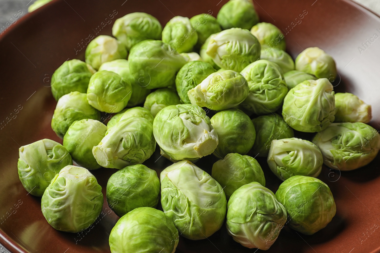 Photo of Tasty fresh Brussels sprouts on plate, closeup