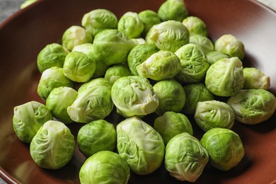 Photo of Tasty fresh Brussels sprouts on plate, closeup