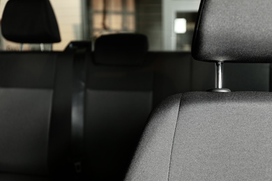 Photo of Car seat with grey upholstery, closeup view