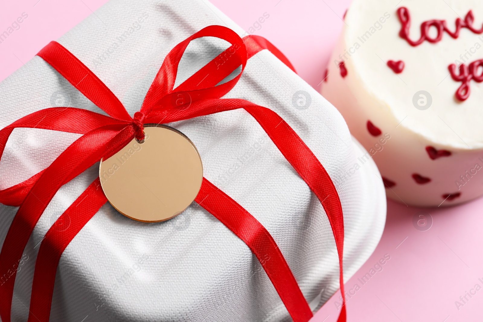 Photo of Takeaway packaging and bento cake on pink table, closeup