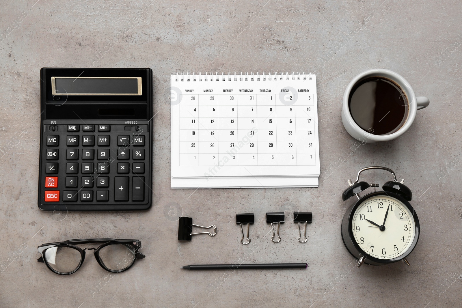 Photo of Flat lay composition with calendar and cup of coffee on grey stone table