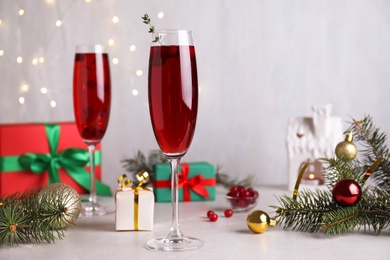 Photo of Delicious Christmas cocktail with liqueur on light table