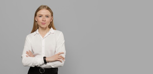 Portrait of beautiful young woman on light grey background. Banner design with space for text