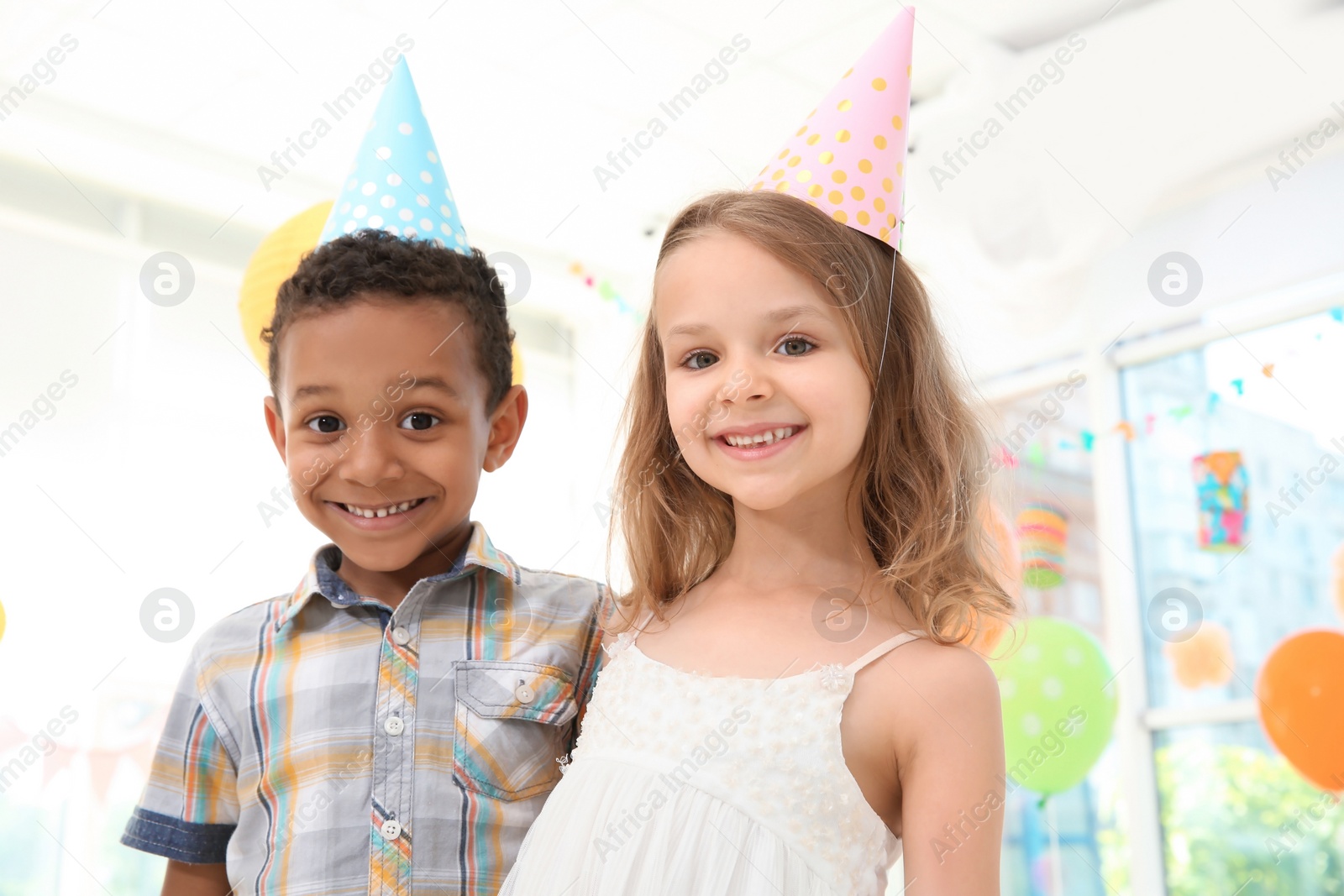 Photo of Cute little children at birthday party indoors