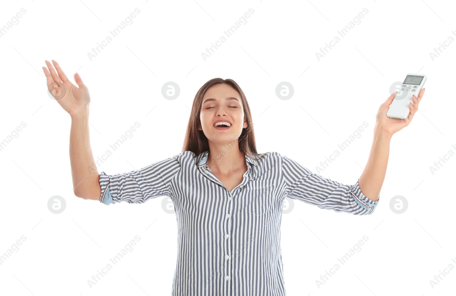 Photo of Happy young woman with air conditioner remote control on white background