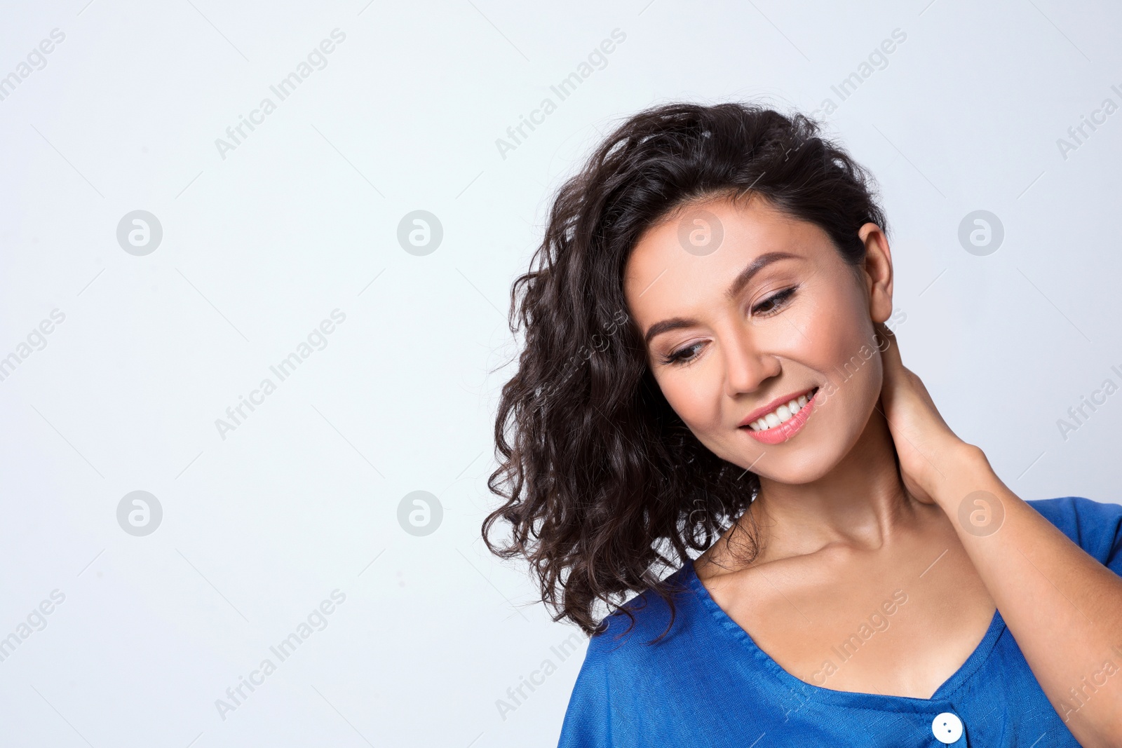 Photo of Happy young woman in casual outfit on light background. Space for text