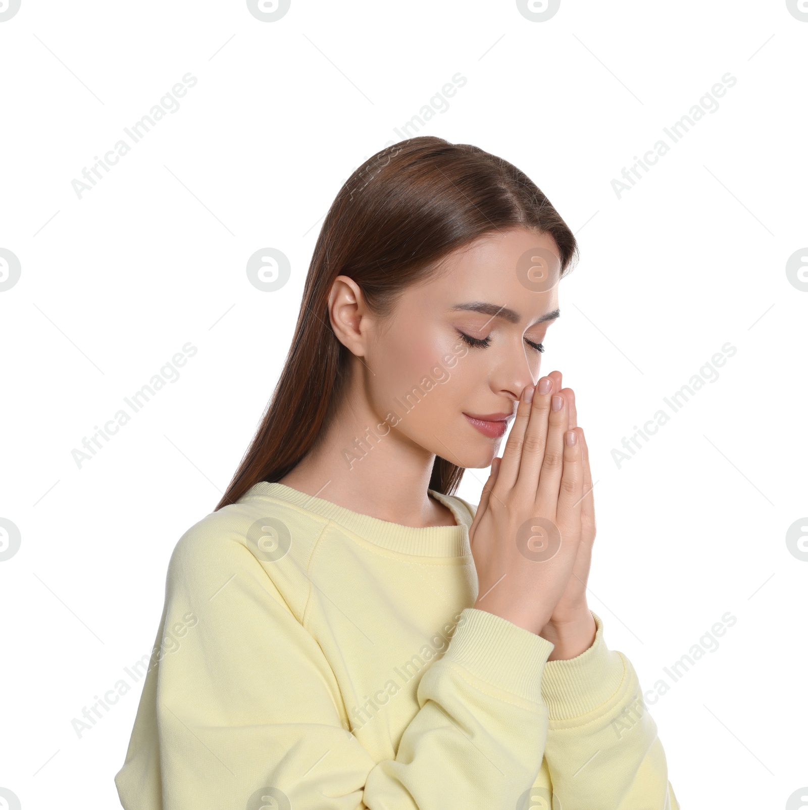 Photo of Woman with clasped hands praying on white background