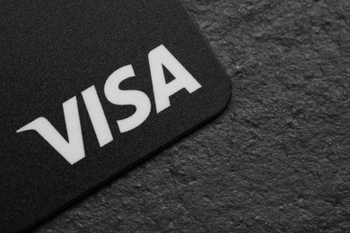 MYKOLAIV, UKRAINE - FEBRUARY 22, 2022: Visa credit card on black background, closeup. Space for text