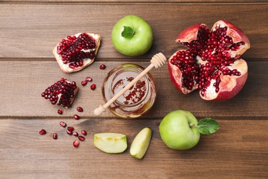 Photo of Honey, pomegranate and apples on wooden table, flat lay. Rosh Hashana holiday