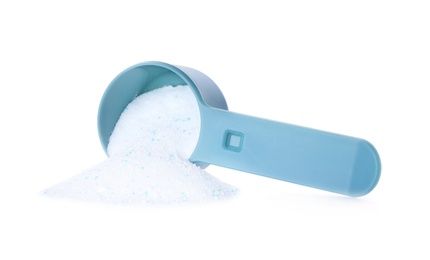 Laundry detergent in plastic measuring scoop on white background