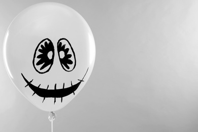 Photo of Spooky balloon for Halloween party on light grey background, space for text