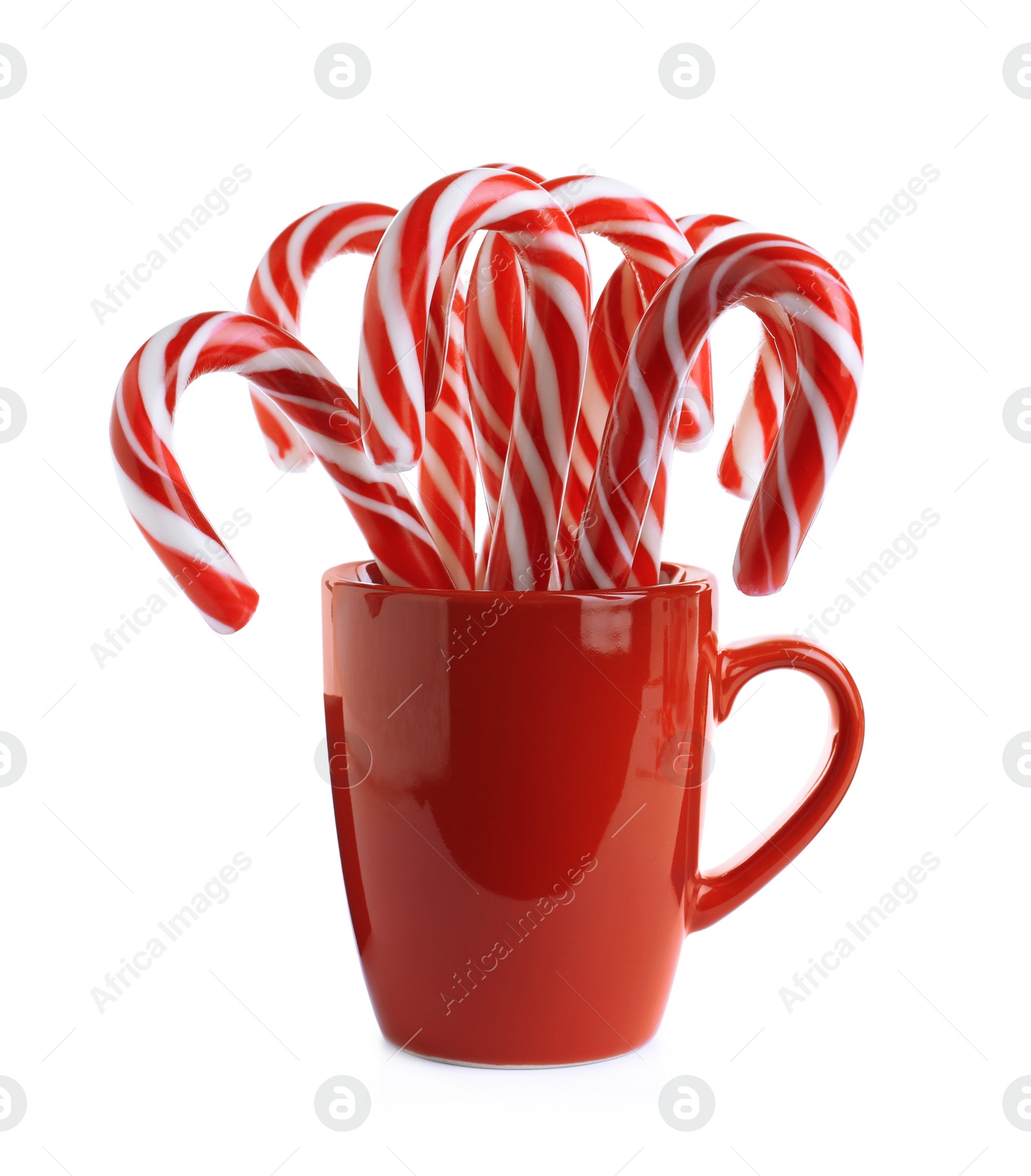 Photo of Red cup with sweet Christmas candy canes isolated on white