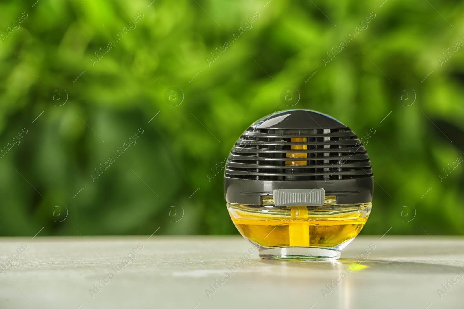 Photo of Car air freshener on table against blurred background