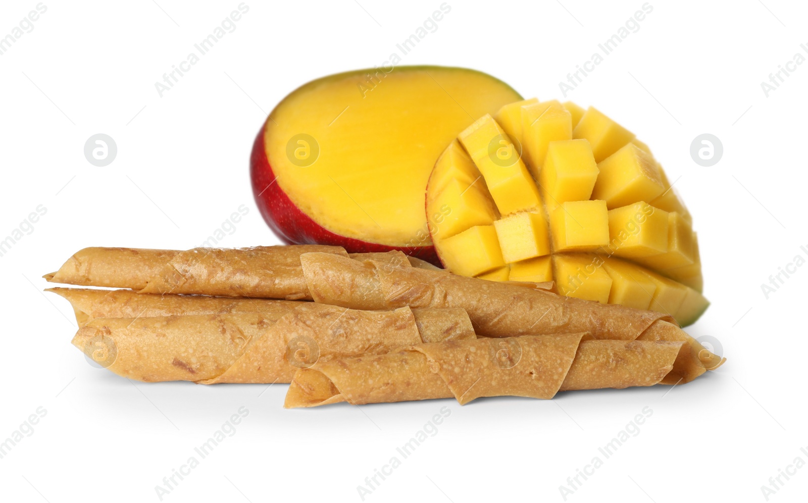 Photo of Delicious fruit leather rolls and mango on white background