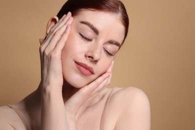 Portrait of beautiful woman on beige background, closeup