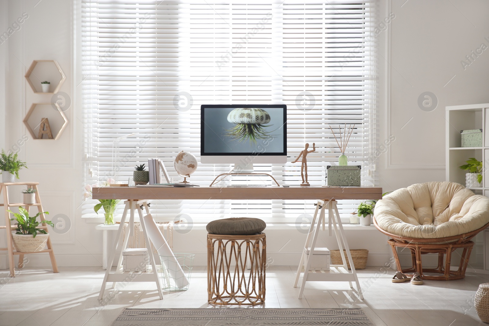 Photo of Stylish home office interior with comfortable workplace and papasan chair