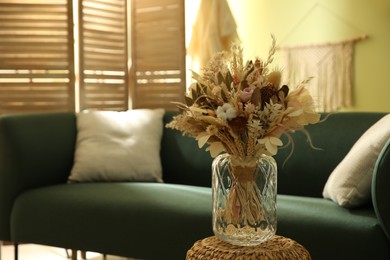 Photo of Bouquet of dry flowers and leaves in living room. Space for text