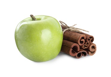 Photo of Cinnamon sticks and green apple on white background