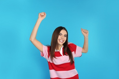 Portrait of emotional young woman on color background