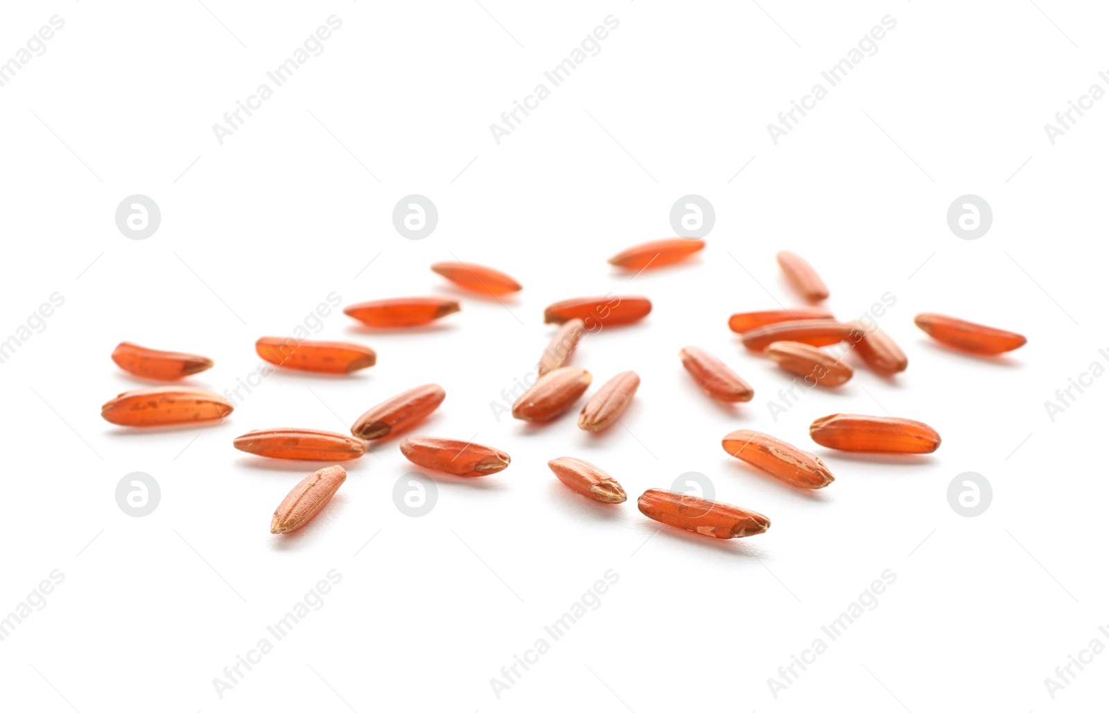 Photo of Scattered grains of brown rice on white background