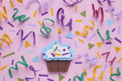 Photo of Birthday party. Paper cupcake and confetti on pink background, flat lay