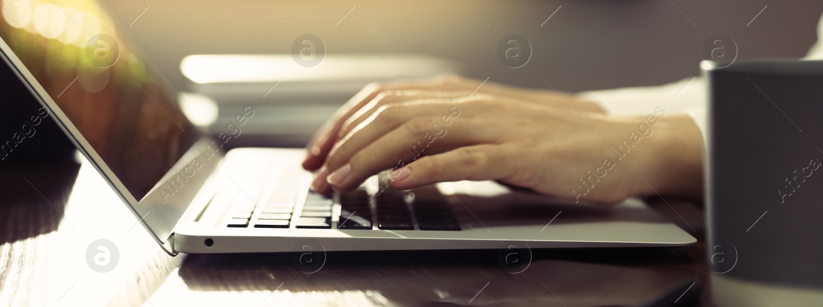 Image of Woman working on computer at table in office, closeup. Banner design