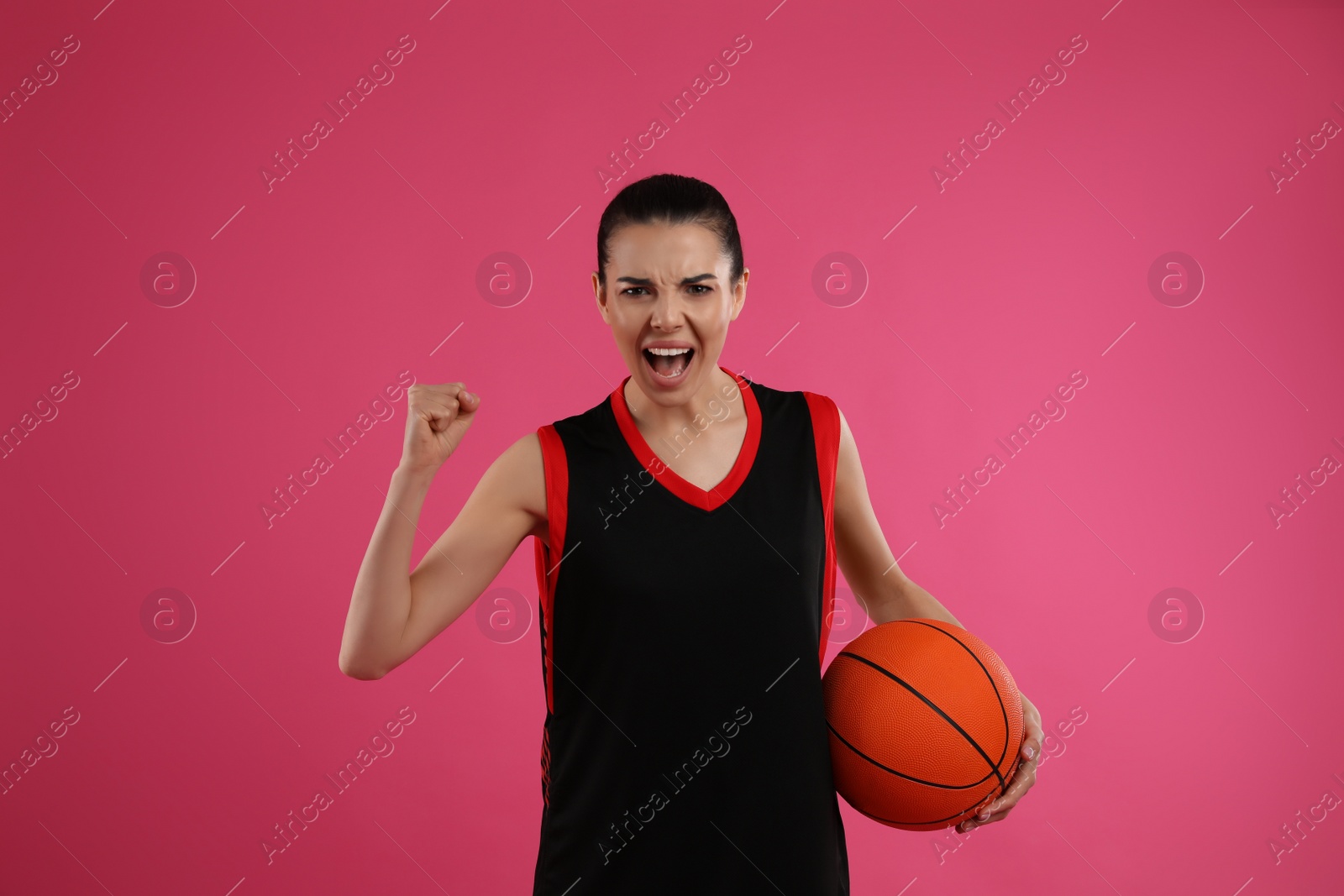 Photo of Basketball player with ball on pink background