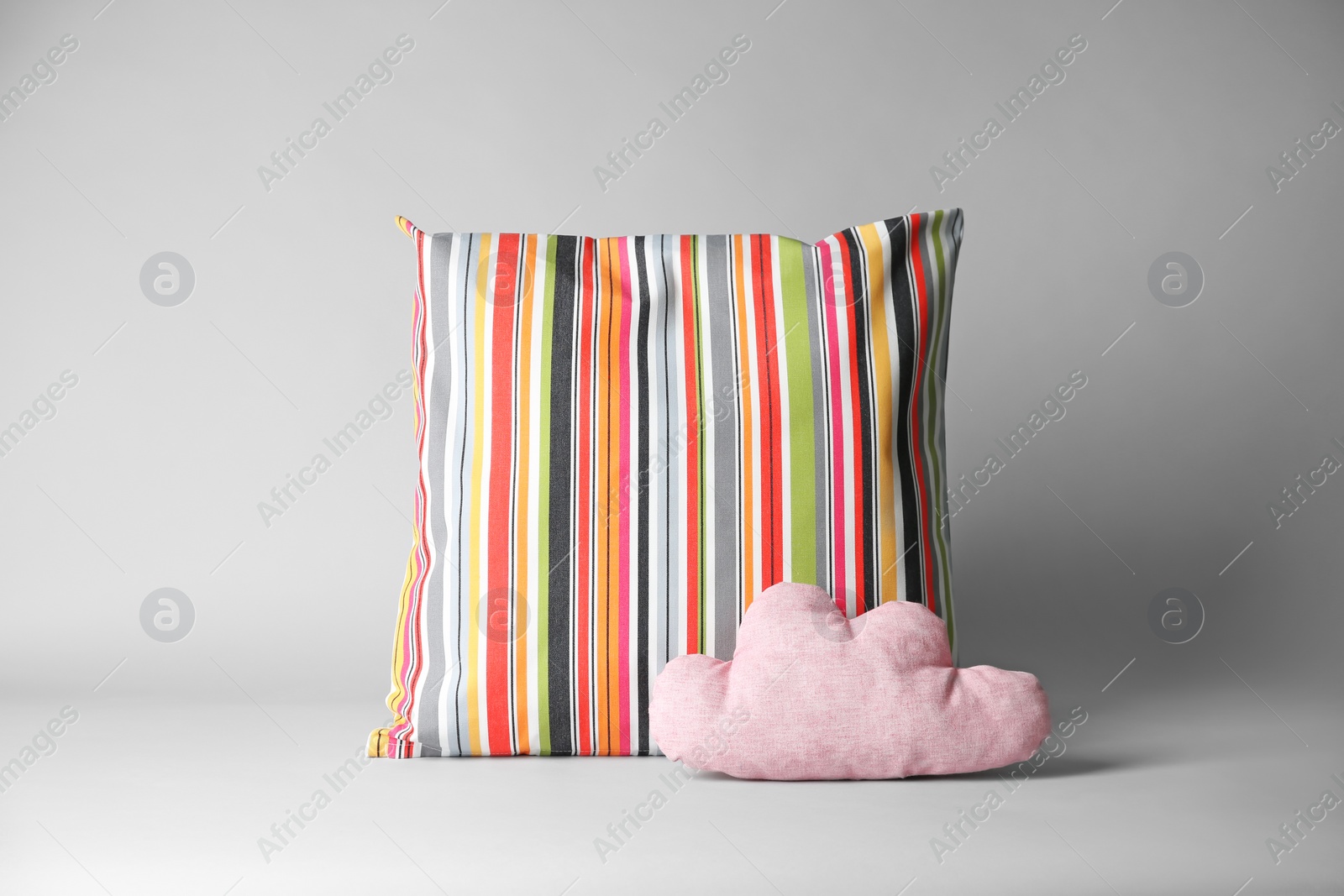 Photo of Soft decorative pillows on light background