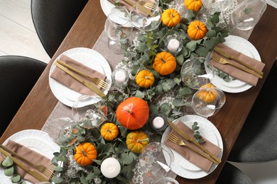 Photo of Beautiful autumn table setting. Plates, cutlery, glasses, pumpkins and floral decor, flat lay