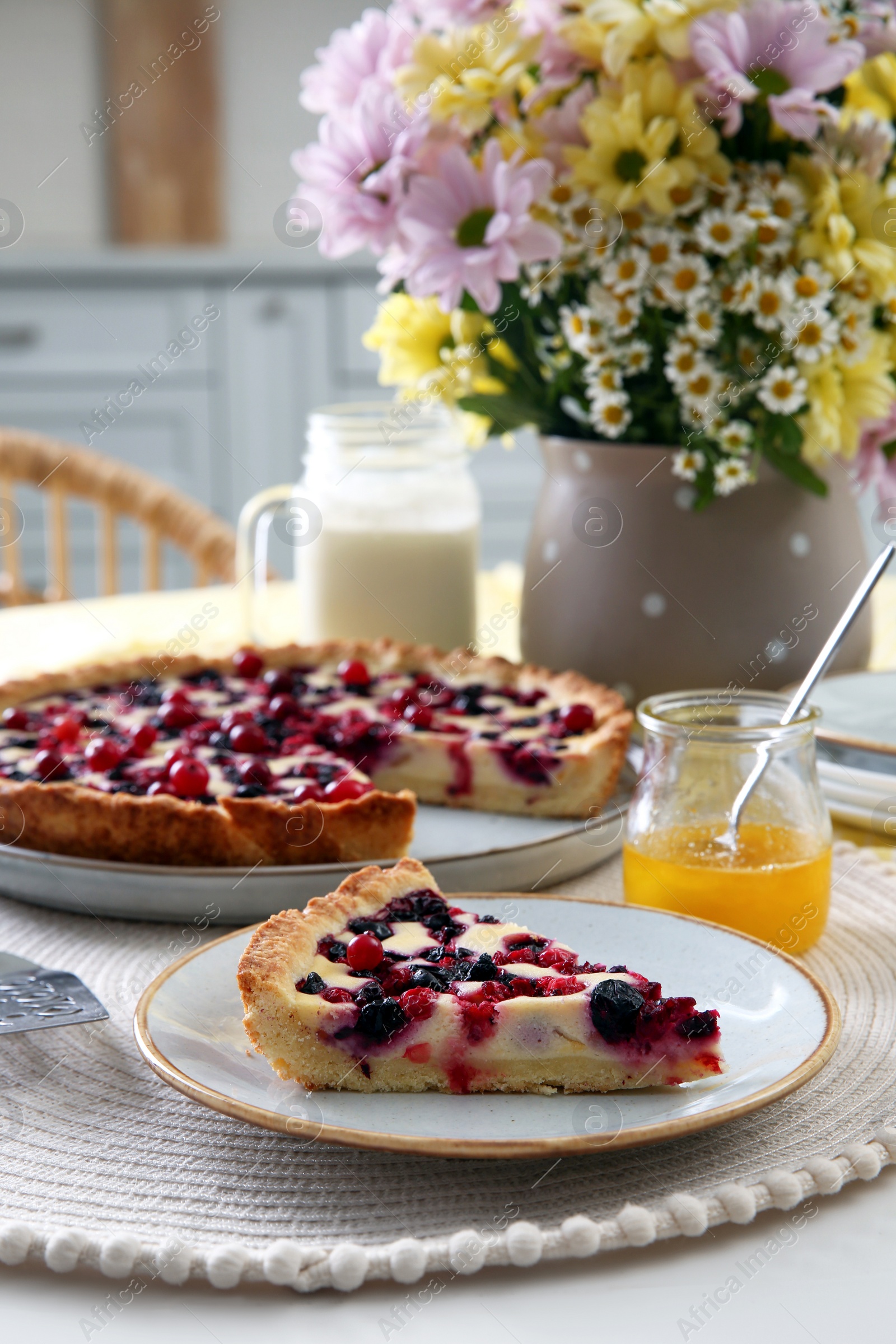 Photo of Piece of delicious currant pie on white table indoors