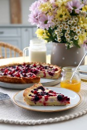 Photo of Piece of delicious currant pie on white table indoors