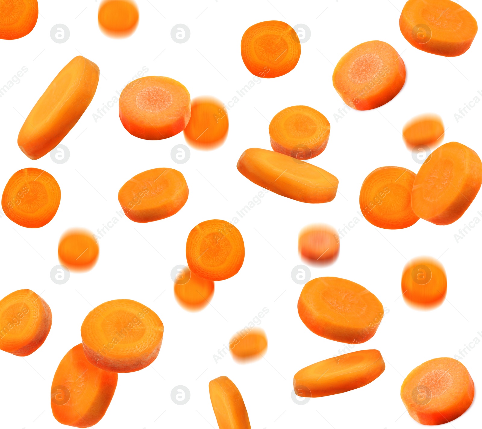 Image of Slices of fresh carrots falling on white background