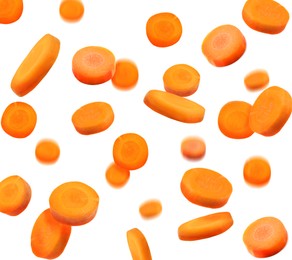 Image of Slices of fresh carrots falling on white background